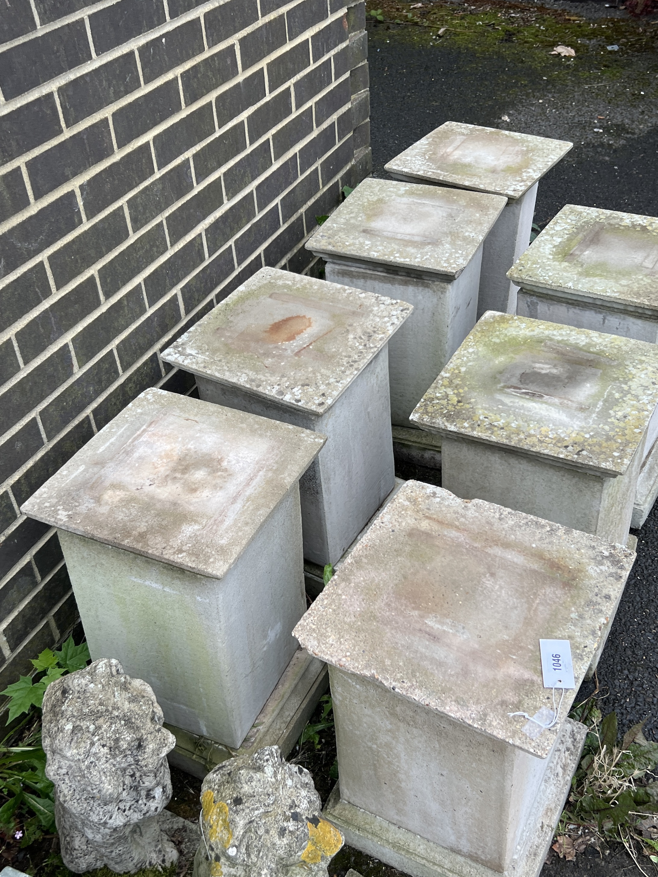 A set of seven square reconstituted stone garden plinths, width 35cm, height 55cm